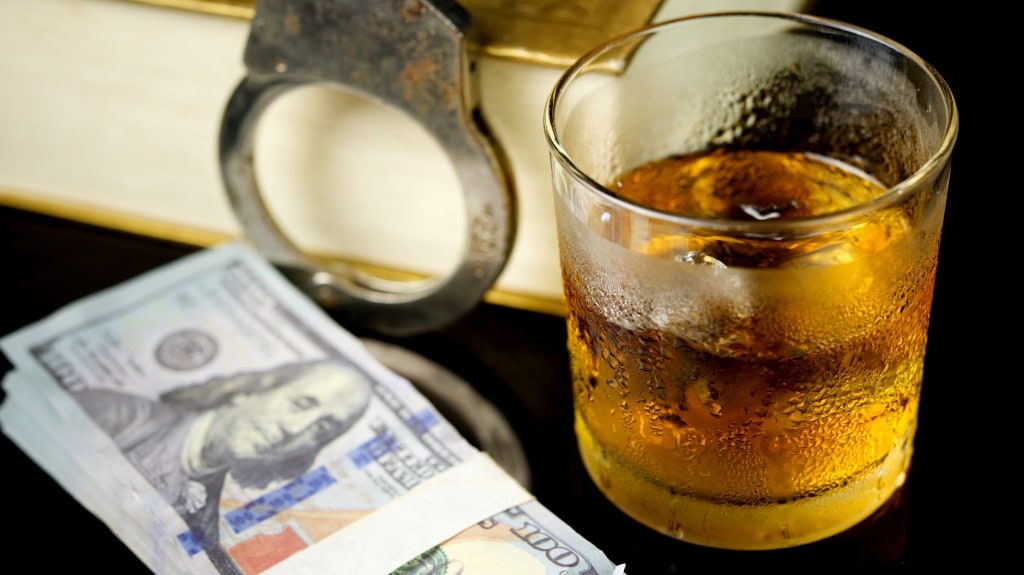 Minor in Possession of Alcohol: Possible Risks glass of whiskey and money