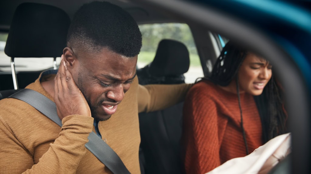 What Does Negligence Mean? man and woman injured in car